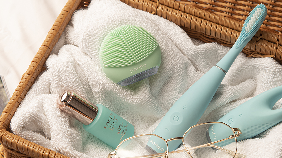 FOREO LUNA 4 go pistachio colored device in a basket with other FOREO devices and skincare products